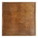 A Lancaster Table & Seating wooden square table top with a brown finish.