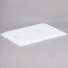 A white plastic lid on a white food storage box.