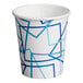 A white paper cup with blue geometric designs.