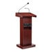 A wooden lectern with a mahogany finish, built-in sound system, and attached microphones.