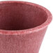 A close up of a red HS Inc. polyethylene ramekin.