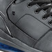 A close up of a black and blue Shoes For Crews Tigon men's athletic shoe.