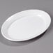 a white oval plate on a gray surface