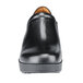 A close-up of a black leather Shoes For Crews Juno women's shoe with a rubber sole.