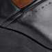 A close up of a black Shoes For Crews Juno shoe with a brown sole.