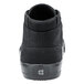 A close-up of a black Shoes For Crews Cabbie II men's shoe with a white sole.