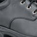 A black leather Shoes For Crews Cade work boot with steel toe.