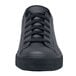 A close up of a black Shoes For Crews Delray men's shoe with laces.