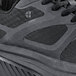 A close up of a black Women's Shoes For Crews Energy II athletic shoe with a mesh upper and rubber sole.