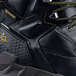 A close up of a black ACE Redrock work boot with a yellow logo on the side.