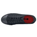 A black Shoes For Crews Delray shoe with a red sole and red logo.