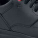 A close-up of a black Shoes For Crews Liberty women's athletic shoe.