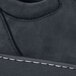 A close up of a black MOZO Mavi shoe with white stitching.