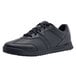 A black Shoes For Crews athletic shoe for men with laces.