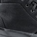 A close up of a black canvas Cabbie II shoe with laces and rubber soles.