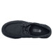 A black Shoes For Crews Milano casual shoe with laces.
