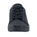 A close up of a MOZO black sneaker with laces and a rubber sole.