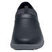 A black Shoes For Crews slip-on shoe with a gray sole.