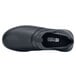 A black Shoes For Crews Alia women's slip-on shoe with a white non-slip sole.