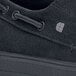 A close up of a black Shoes For Crews Milano women's water-resistant non-slip shoe.