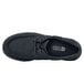 A black Shoes For Crews Milano water-resistant casual shoe with laces.
