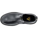 A close-up of a black ACE Firebrand work boot with yellow stitching.