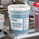 A white container of Noble Chemical Dry It Plus.