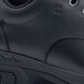 A close up of a black leather Shoes For Crews Rae work boot with a rubber sole.