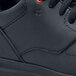 A close up of a black Shoes For Crews Liberty athletic shoe.