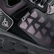 The back of a black and gray ACE Aster athletic shoe.