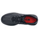 A black Shoes For Crews Freestyle II athletic shoe with a red sole.