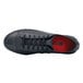 A black leather Shoes For Crews men's shoe with red laces.