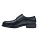 A black leather Shoes For Crews Senator steel toe dress shoe with laces and a rubber sole.
