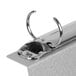 The brushed aluminum Menu Solutions Alumitique Menu Tent with top rings on a table in a bar.
