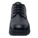 A close-up of a black Shoes For Crews Cade work shoe with laces.