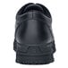 The back of a black Shoes For Crews Cade work boot with white stitching.