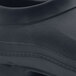 A close up of a black Shoes For Crews Radium shoe with rubber soles.