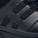 A black Shoes For Crews Karina athletic shoe with two side straps.