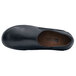 A black water-resistant Shoes For Crews Kelsey women's casual shoe with a brown sole.