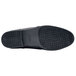 A close-up of the black Shoes For Crews Madison III women's shoe with a rubber sole.