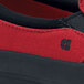 A close up of a red and black Shoes For Crews Ollie II canvas shoe with a black sole.