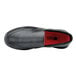 A black Shoes For Crews men's slip-on shoe with a red sole.