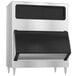 A stainless steel rectangular ice storage bin with black doors.