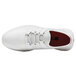 A white Shoes For Crews Karina athletic shoe with red accents.
