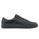 A black leather Shoes For Crews low rider shoe with laces and a rubber sole.