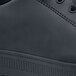 A black leather Shoes For Crews men's casual shoe with a rubber sole and toe.