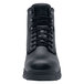A close-up of a black Shoes For Crews work boot with laces and a rubber sole.