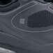 A close-up of a black Shoes For Crews Revolution II women's athletic shoe.