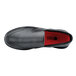 A black Shoes For Crews men's slip-on shoe with a red sole.