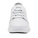 A white Shoes For Crews women's athletic shoe with laces and a white sole.
